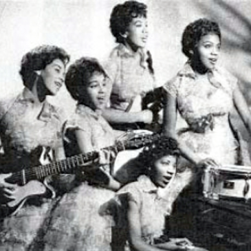 five young african american women in matching dresses, some are playing instruments (guitar, piano, and a drum)