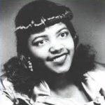 black and white photo of an african american woman with long, curly hair