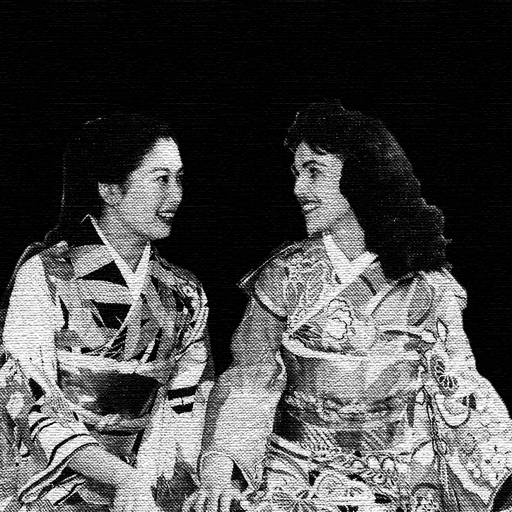 two women in kimonos, one white and one Asian.